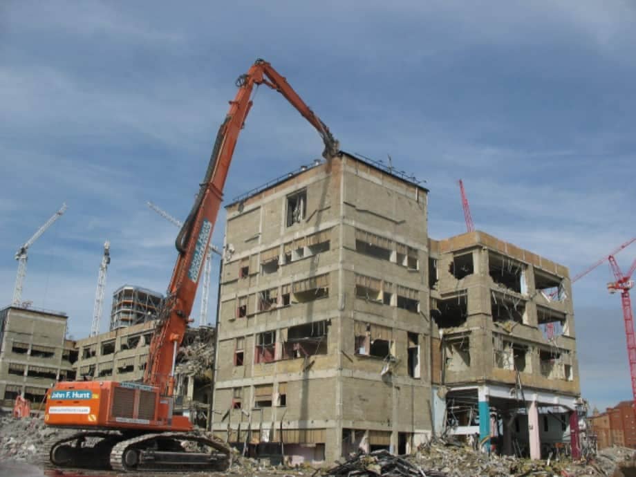 demolition of buildings using high reach excavator